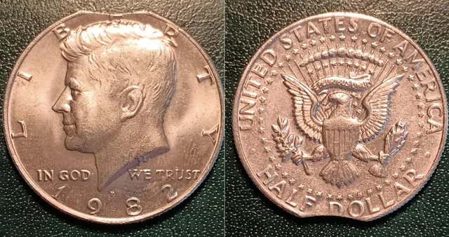 1982 Kennedy half dollar clipped planchet error showing a curved bite taken from the coin's edge